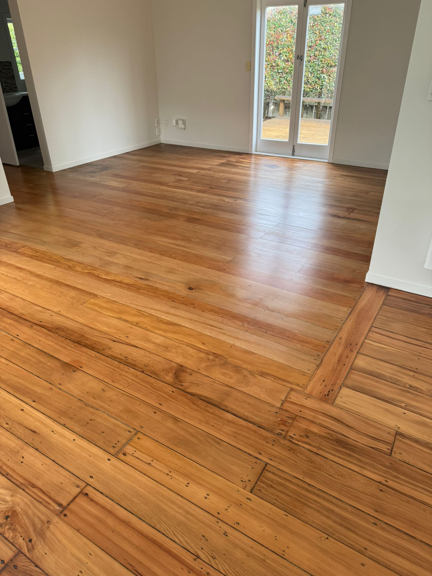 Restored native timber living room floor with a warm honey finish