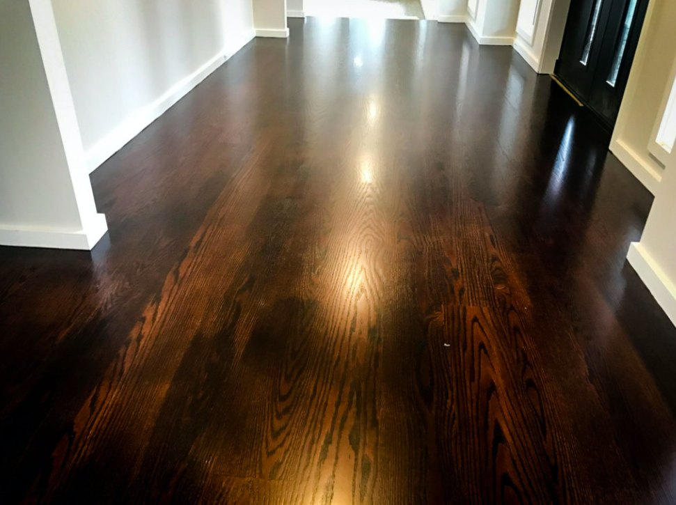Deep walnut stained hardwood hallway floor after refinishing